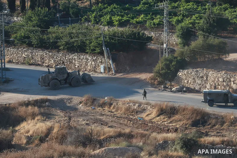 Israeli army vehicles place earth mounds and concrete blocks at roads and entrances to the town of Beit Ummar, north of Hebron in the occupied West Bank, on June 9, 2026. According to local sources, Israeli forces have c...