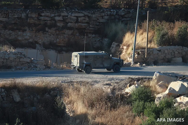 Israeli army vehicles place earth mounds and concrete blocks at roads and entrances to the town of Beit Ummar, north of Hebron in the occupied West Bank, on June 9, 2026. According to local sources, Israeli forces have c...