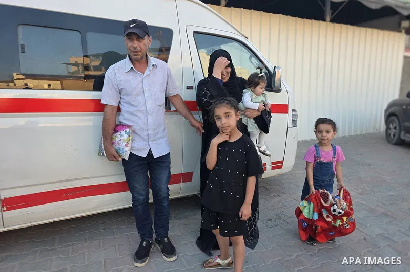 Palestinian patients and wounded people, accompanied by their relatives, return to the Gaza Strip through the Israeli-controlled Kerem Shalom crossing after completing medical treatment in Jordan, in Khan Younis, souther...