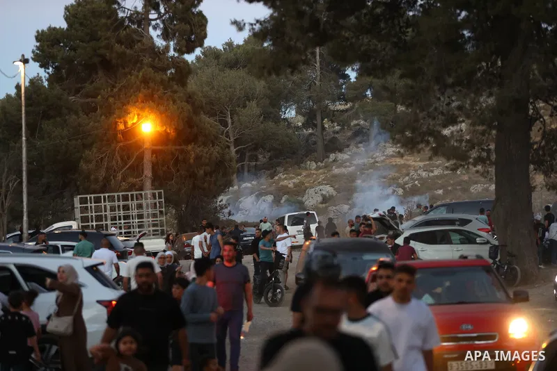 Palestinians run for cover as Israeli forces fire tear gas canisters toward visitors at the historic Solomon’s Pools area, south of Bethlehem in the occupied West Bank, on June 12, 2026. The incident occurred while peopl...