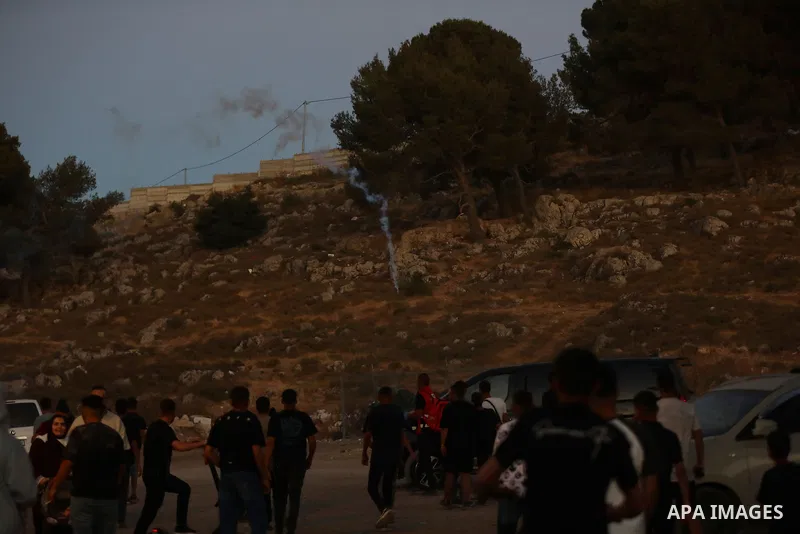 Palestinians run for cover as Israeli forces fire tear gas canisters toward visitors at the historic Solomon’s Pools area, south of Bethlehem in the occupied West Bank, on June 12, 2026. The incident occurred while peopl...