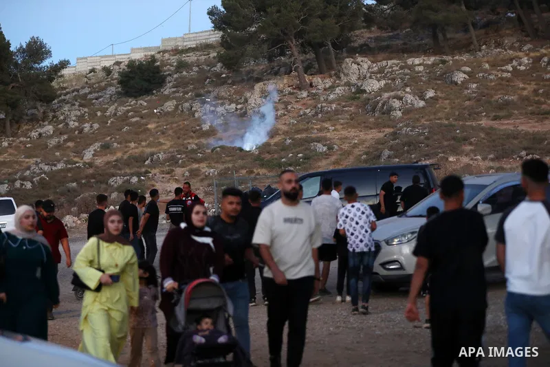 Palestinians run for cover as Israeli forces fire tear gas canisters toward visitors at the historic Solomon’s Pools area, south of Bethlehem in the occupied West Bank, on June 12, 2026. The incident occurred while peopl...