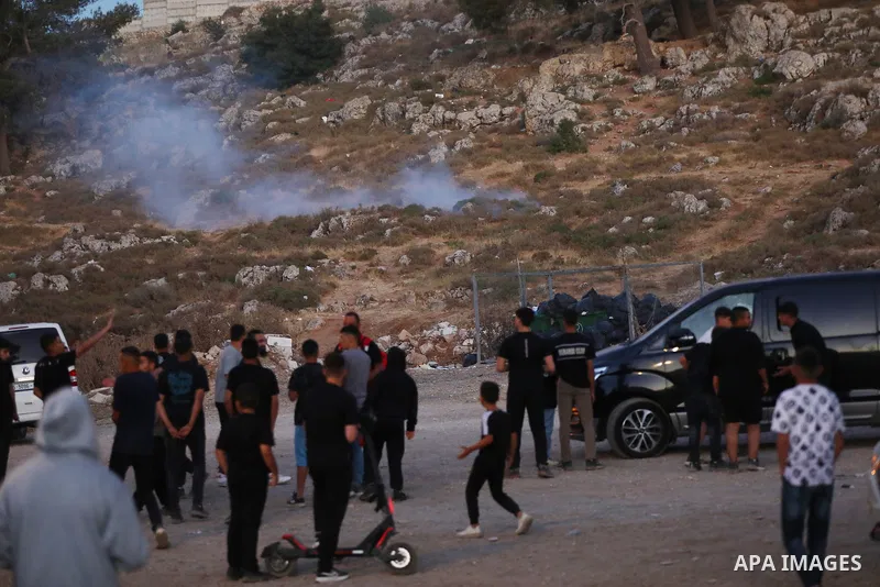 Palestinians run for cover as Israeli forces fire tear gas canisters toward visitors at the historic Solomon’s Pools area, south of Bethlehem in the occupied West Bank, on June 12, 2026. The incident occurred while peopl...