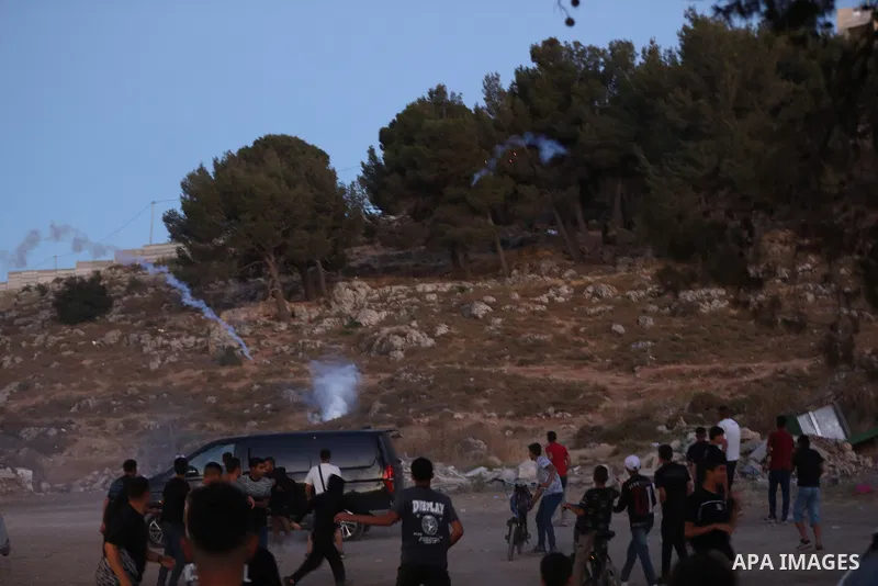 Palestinians run for cover as Israeli forces fire tear gas canisters toward visitors at the historic Solomon’s Pools area, south of Bethlehem in the occupied West Bank, on June 12, 2026. The incident occurred while peopl...