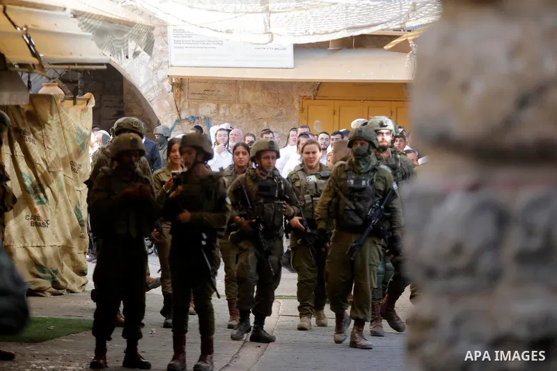 Israeli soldiers keep watch during a weekly Israeli settlers' tour in Hebron, in the Israeli-occupied West Bank, June 20, 2026. Photo by Mamoun Wazwaz\ apaimages