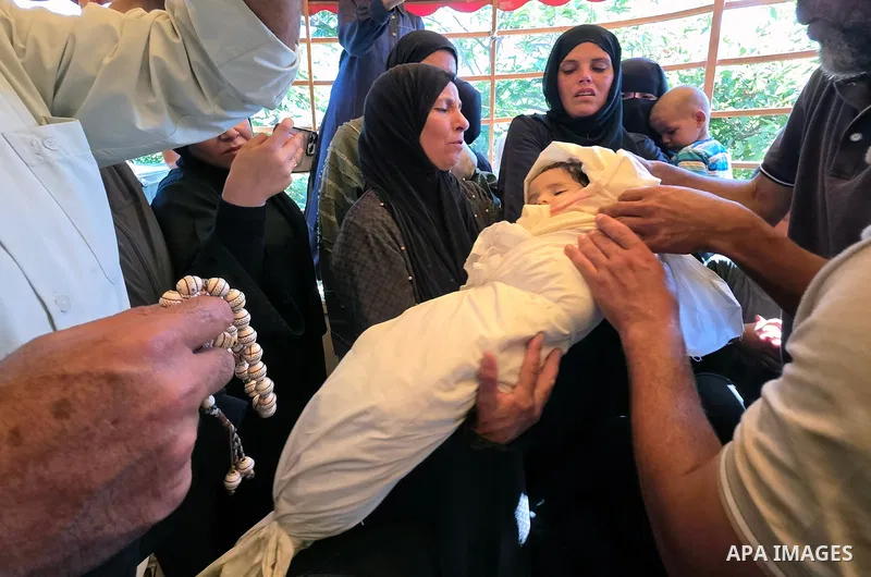 Mourners carry the bodies of infant Suwar Abu Daraz and her mother, Diana Abu Daraz, during their funeral at Nasser Medical Complex in Khan Younis, southern Gaza Strip, on June 30, 2026. The mother and her infant daughte...