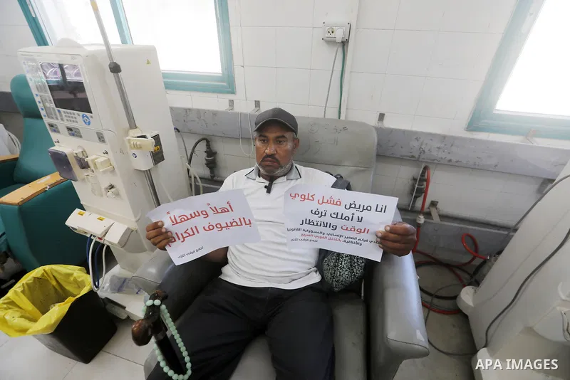 Patients with chronic kidney disease take part in a protest outside the Kidney Diseases Building at al-Shifa Hospital in Gaza City on June 30, 2026, protesting the reduction in the duration and number of dialysis session...