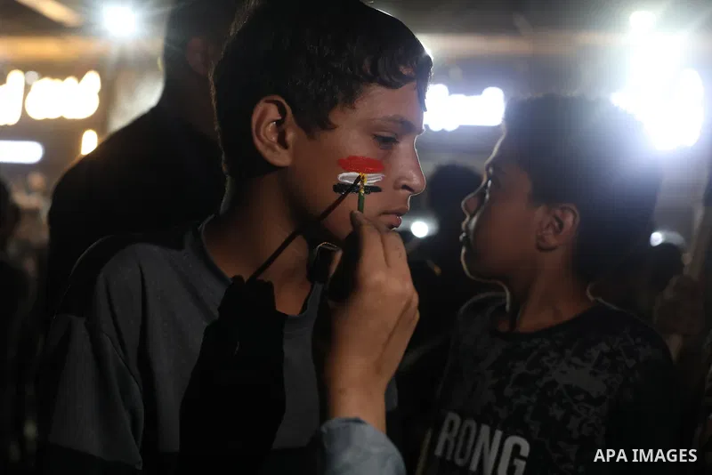 Palestinians watch a live broadcast of the FIFA World Cup Round of 32 football match between Egypt and Australia in Gaza City, on July 3, 2026. Residents gathered to follow the knockout-stage match on a public screen ami...