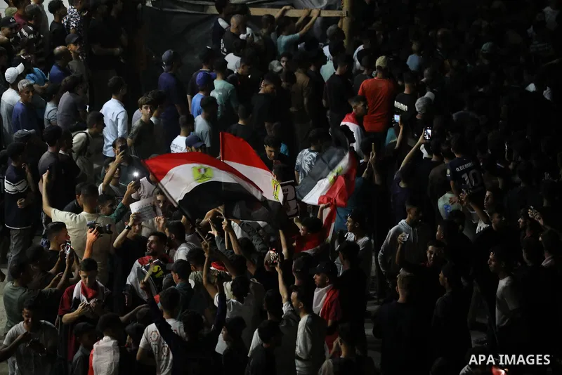 Palestinians watch a live broadcast of the FIFA World Cup Round of 32 football match between Egypt and Australia in Gaza City, on July 3, 2026. Residents gathered to follow the knockout-stage match on a public screen ami...