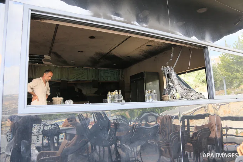 Palestinians inspect the damage after Israeli settlers set fire to a restaurant near Al-Zaytouna University, near the city of Salfit in the northern West Bank, on July 5, 2026. According to local accounts, settlers attac...