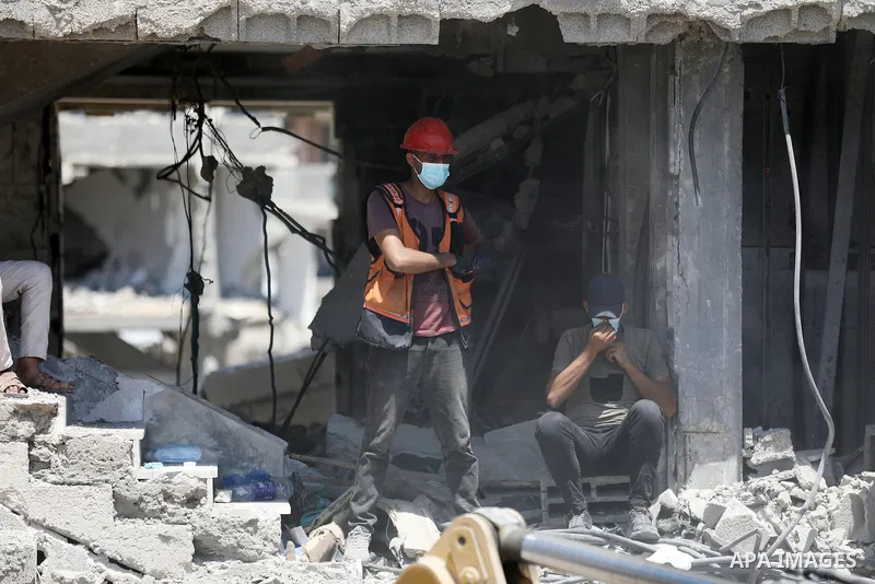 Members of the Palestinian Civil Defense search for and attempt to recover the remains of 153 people from beneath the rubble of a destroyed house belonging to the Abu Sharia family in the Sabra neighborhood of Gaza City,...