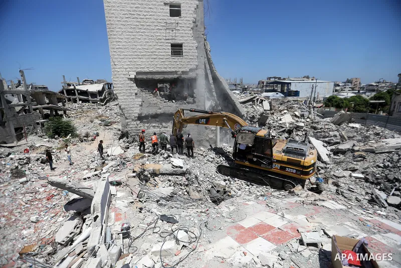 Members of the Palestinian Civil Defense search for and attempt to recover the remains of 153 people from beneath the rubble of a destroyed house belonging to the Abu Sharia family in the Sabra neighborhood of Gaza City,...