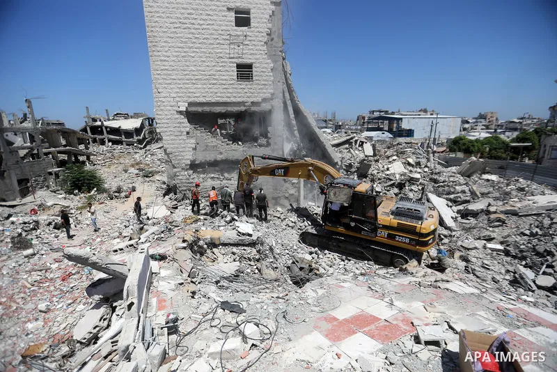 Members of the Palestinian Civil Defense search for and attempt to recover the remains of 153 people from beneath the rubble of a destroyed house belonging to the Abu Sharia family in the Sabra neighborhood of Gaza City,...