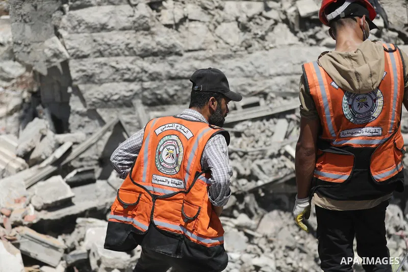 Members of the Palestinian Civil Defense search for and attempt to recover the remains of 153 people from beneath the rubble of a destroyed house belonging to the Abu Sharia family in the Sabra neighborhood of Gaza City,...