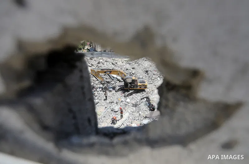 Members of the Palestinian Civil Defense search for and attempt to recover the remains of 153 people from beneath the rubble of a destroyed house belonging to the Abu Sharia family in the Sabra neighborhood of Gaza City,...