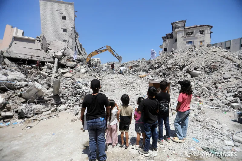 Members of the Palestinian Civil Defense search for and attempt to recover the remains of 153 people from beneath the rubble of a destroyed house belonging to the Abu Sharia family in the Sabra neighborhood of Gaza City,...