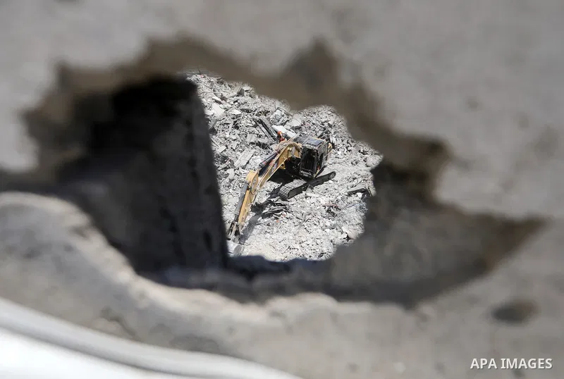 Members of the Palestinian Civil Defense search for and attempt to recover the remains of 153 people from beneath the rubble of a destroyed house belonging to the Abu Sharia family in the Sabra neighborhood of Gaza City,...
