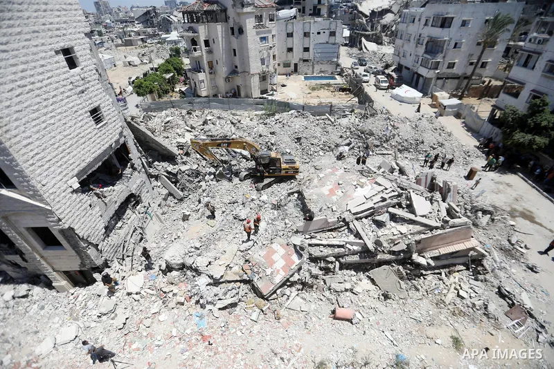 Members of the Palestinian Civil Defense search for and attempt to recover the remains of 153 people from beneath the rubble of a destroyed house belonging to the Abu Sharia family in the Sabra neighborhood of Gaza City,...