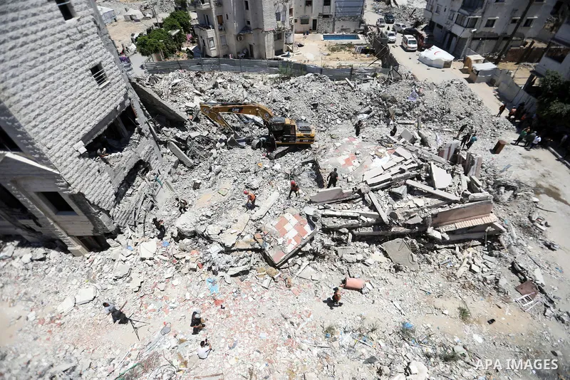 Members of the Palestinian Civil Defense search for and attempt to recover the remains of 153 people from beneath the rubble of a destroyed house belonging to the Abu Sharia family in the Sabra neighborhood of Gaza City,...