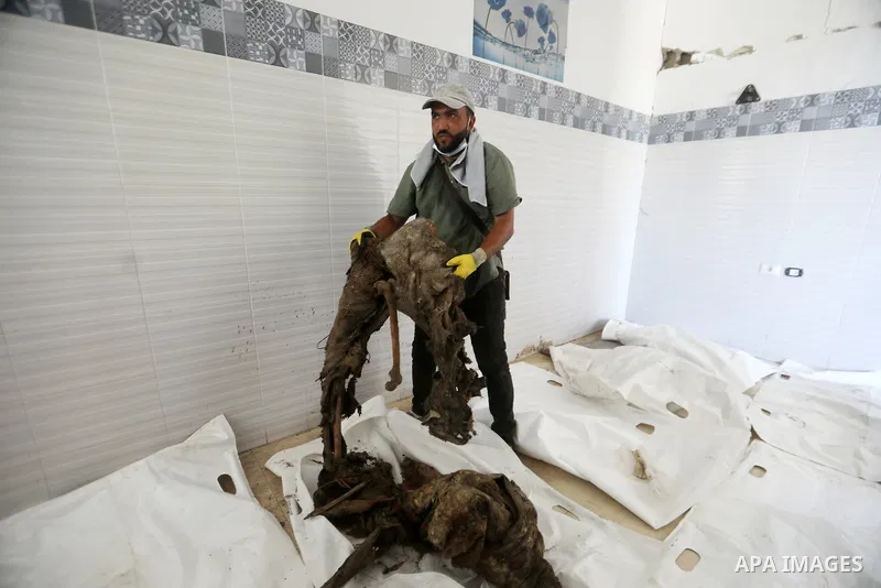 A Palestinian man attempts to identify human remains recovered from beneath the rubble of destroyed buildings during the second phase of search and recovery operations carried out by the Palestinian Civil Defense in the...