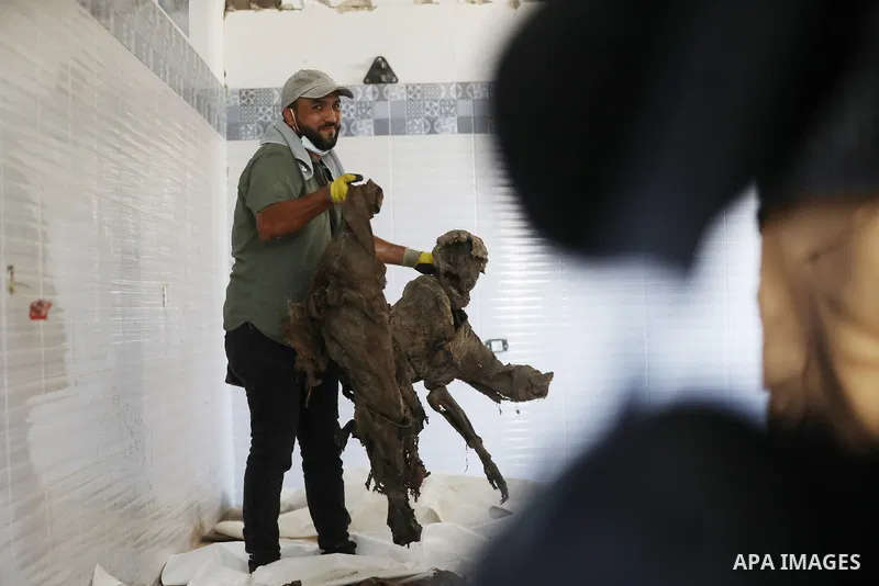 A Palestinian man attempts to identify human remains recovered from beneath the rubble of destroyed buildings during the second phase of search and recovery operations carried out by the Palestinian Civil Defense in the...