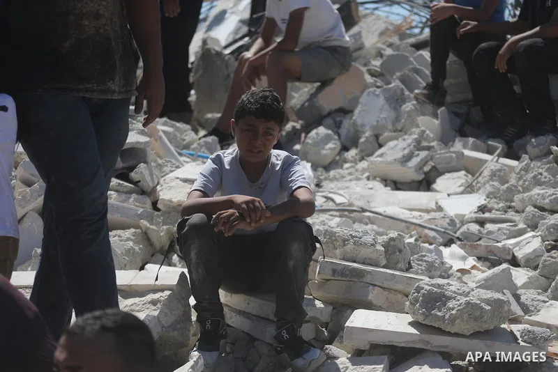 Palestinians sit on the rubble of a home demolished by Israeli forces in the town of Beit Awa, south of Hebron, in the occupied West Bank, on July 20, 2026. The house belonged to Ahmad Masalma, whose family inspected the...