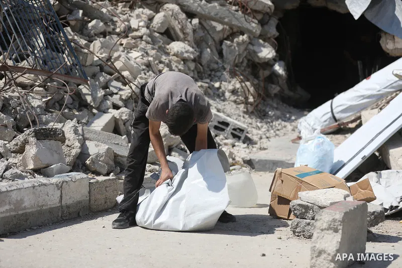 Displaced Palestinians carry their belongings as they flee the Dawla area near Salah al-Din Street in the Zeitoun neighborhood of Gaza City, on July 22, 2026, after the Israeli army advanced concrete barriers locally kno...