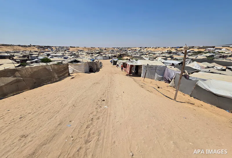 Displaced Palestinians remain in tents at camps near the al-Mawasi area, west of Khan Younis, southern Gaza Strip, on July 23, 2026, despite recurring Israeli gunfire targeting the area. Residents say the camps come unde...
