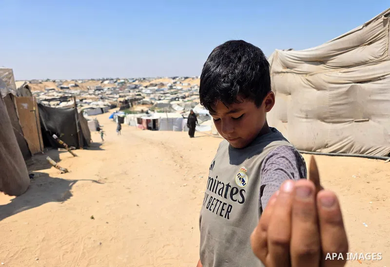 Displaced Palestinians remain in tents at camps near the al-Mawasi area, west of Khan Younis, southern Gaza Strip, on July 23, 2026, despite recurring Israeli gunfire targeting the area. Residents say the camps come unde...