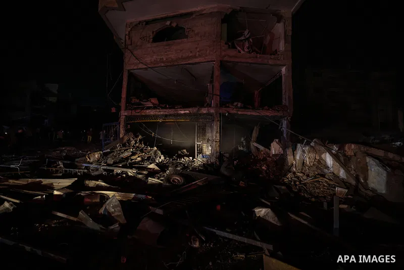 Palestinians inspect the damage to a building following an Israeli airstrike on al-Jalaa Street in central Gaza City, Gaza Strip, on July 23, 2026. Photo by Omar Ashtawy\ apaimages