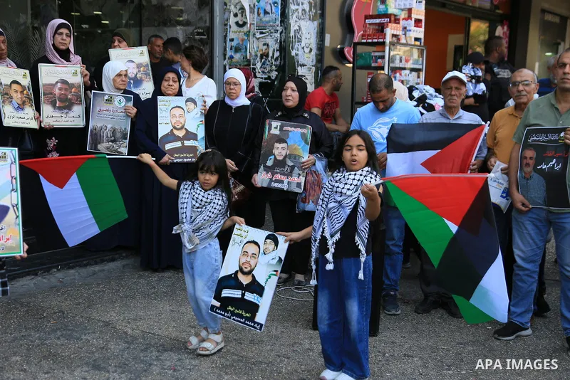 Palestinians take part in a solidarity rally in support of Palestinian prisoners held in Israeli jails in the center of Nablus, in the occupied West Bank, on July 28, 2026. Participants held portraits of the prisoners an...