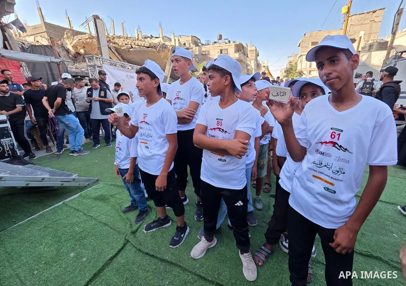 Palestinian children take part in a marathon among the rubble of the al-Amal neighborhood in Khan Younis, southern Gaza Strip, on July 31, 2026. The event coincides with the launch of the neighborhood's first initiative...