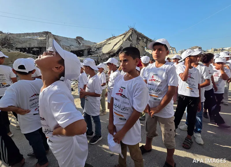 Palestinian children take part in a marathon among the rubble of the al-Amal neighborhood in Khan Younis, southern Gaza Strip, on July 31, 2026. The event coincides with the launch of the neighborhood's first initiative...