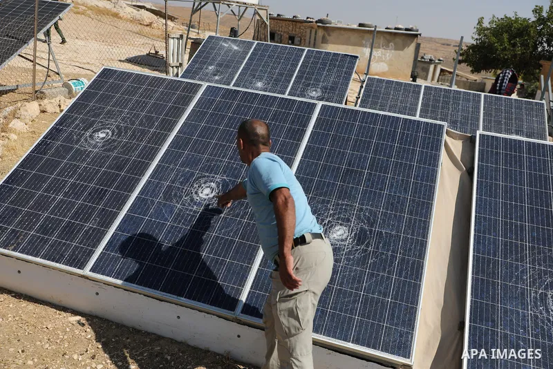 Palestinians inspect damage in Khirbet al-Tuba, in the Masafer Yatta area south of Hebron in the occupied West Bank, on August 6, 2026, after residents said Israeli settlers attacked the community, damaging several homes...