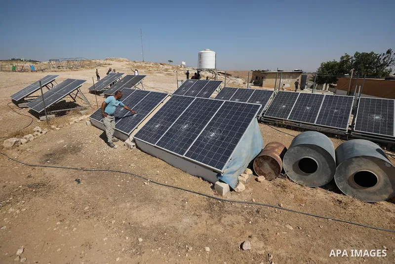 Palestinians inspect damage in Khirbet al-Tuba, in the Masafer Yatta area south of Hebron in the occupied West Bank, on August 6, 2026, after residents said Israeli settlers attacked the community, damaging several homes...
