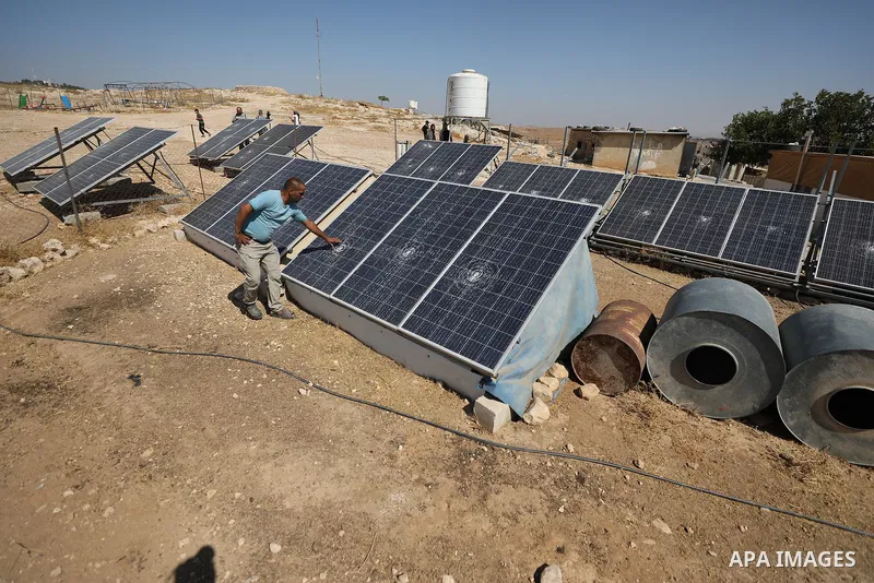Palestinians inspect damage in Khirbet al-Tuba, in the Masafer Yatta area south of Hebron in the occupied West Bank, on August 6, 2026, after residents said Israeli settlers attacked the community, damaging several homes...