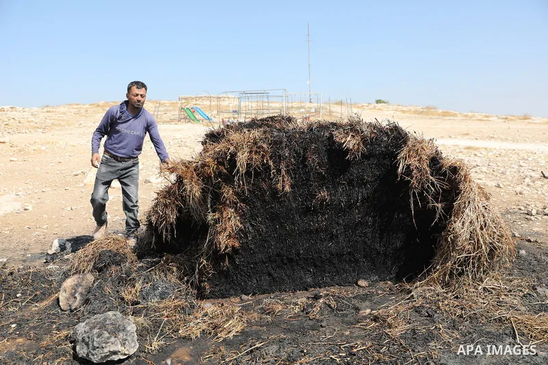Palestinians inspect damage in Khirbet al-Tuba, in the Masafer Yatta area south of Hebron in the occupied West Bank, on August 6, 2026, after residents said Israeli settlers attacked the community, damaging several homes...