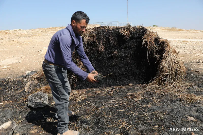 Palestinians inspect damage in Khirbet al-Tuba, in the Masafer Yatta area south of Hebron in the occupied West Bank, on August 6, 2026, after residents said Israeli settlers attacked the community, damaging several homes...
