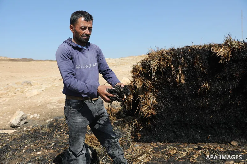 Palestinians inspect damage in Khirbet al-Tuba, in the Masafer Yatta area south of Hebron in the occupied West Bank, on August 6, 2026, after residents said Israeli settlers attacked the community, damaging several homes...
