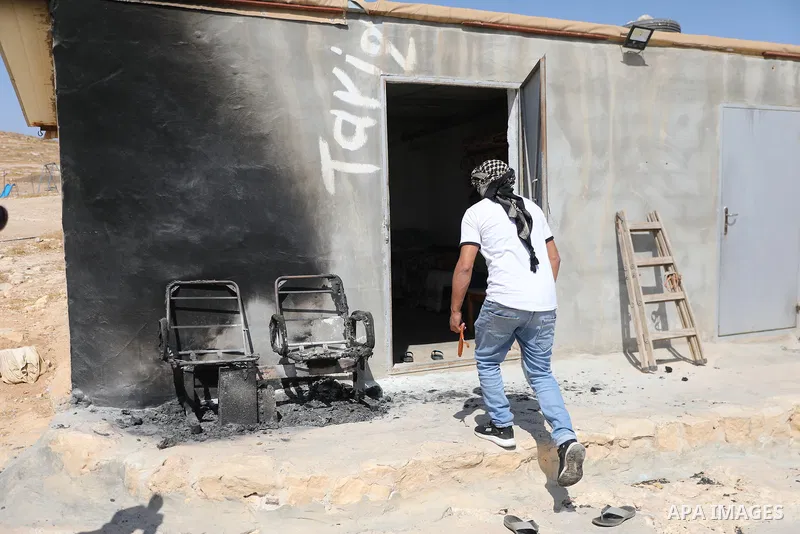 Palestinians inspect damage in Khirbet al-Tuba, in the Masafer Yatta area south of Hebron in the occupied West Bank, on August 6, 2026, after residents said Israeli settlers attacked the community, damaging several homes...
