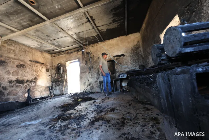 Palestinians inspect damage in Khirbet al-Tuba, in the Masafer Yatta area south of Hebron in the occupied West Bank, on August 6, 2026, after residents said Israeli settlers attacked the community, damaging several homes...