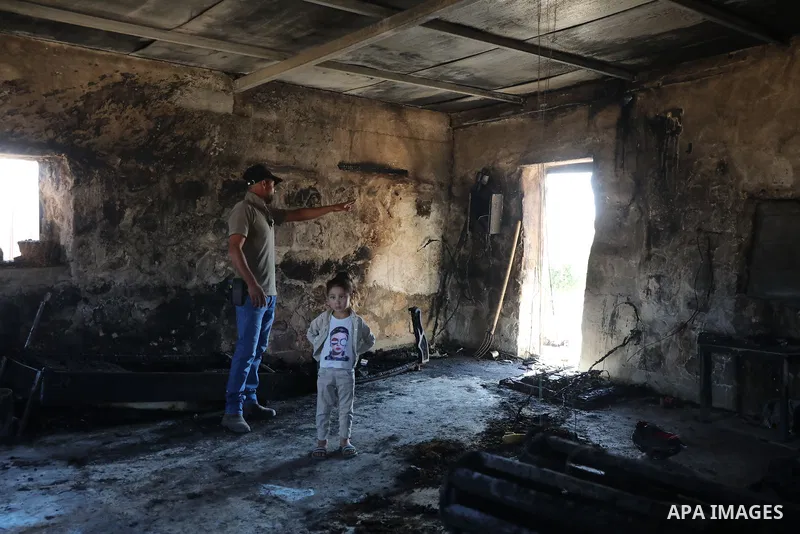 Palestinians inspect damage in Khirbet al-Tuba, in the Masafer Yatta area south of Hebron in the occupied West Bank, on August 6, 2026, after residents said Israeli settlers attacked the community, damaging several homes...