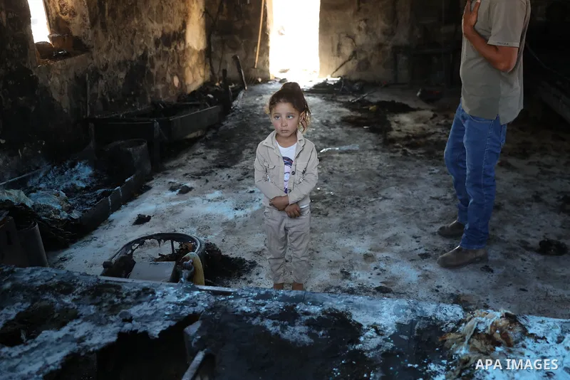 Palestinians inspect damage in Khirbet al-Tuba, in the Masafer Yatta area south of Hebron in the occupied West Bank, on August 6, 2026, after residents said Israeli settlers attacked the community, damaging several homes...