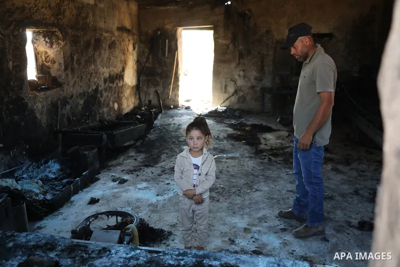 Palestinians inspect damage in Khirbet al-Tuba, in the Masafer Yatta area south of Hebron in the occupied West Bank, on August 6, 2026, after residents said Israeli settlers attacked the community, damaging several homes...