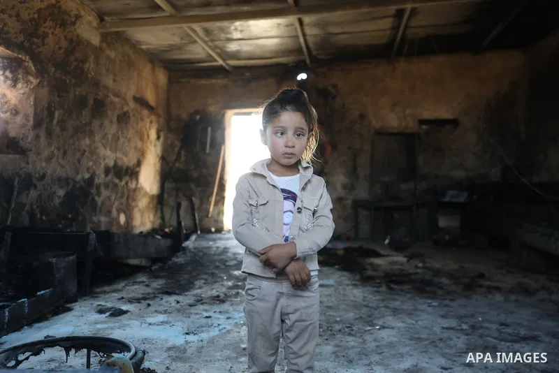 Palestinians inspect damage in Khirbet al-Tuba, in the Masafer Yatta area south of Hebron in the occupied West Bank, on August 6, 2026, after residents said Israeli settlers attacked the community, damaging several homes...