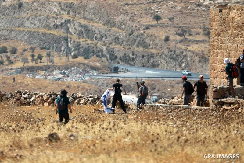 Palestinians and international activists take part in clashes after Israeli settlers opened fire with live ammunition as the group accompanied Palestinian landowners to properties threatened with confiscation in the West...