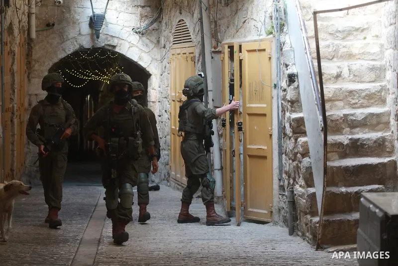 Israeli soldiers deploy in the Old City of Hebron in the West Bank, on August 15, 2026, as Israeli settlers tour the area under their protection after forces closed roads and alleys, restricting the movement of Palestini...