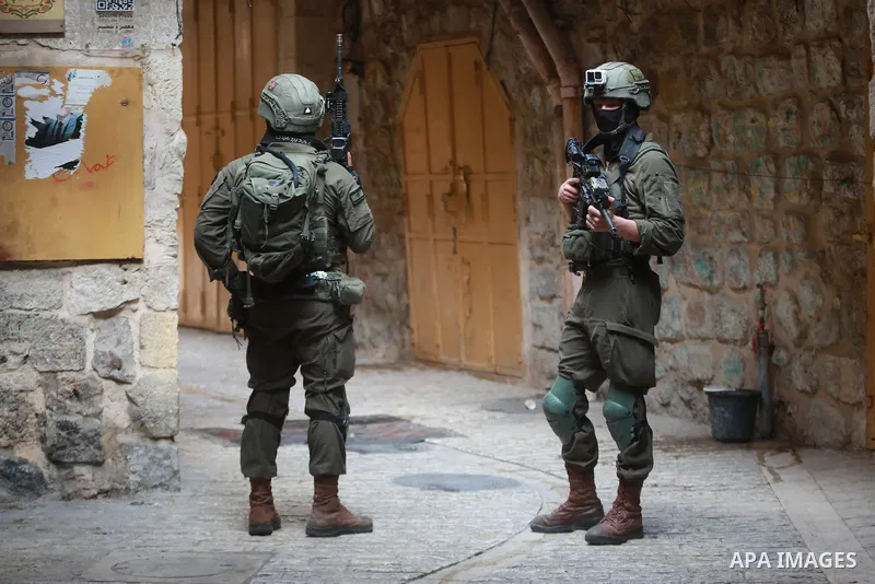 Israeli soldiers deploy in the Old City of Hebron in the West Bank, on August 15, 2026, as Israeli settlers tour the area under their protection after forces closed roads and alleys, restricting the movement of Palestini...