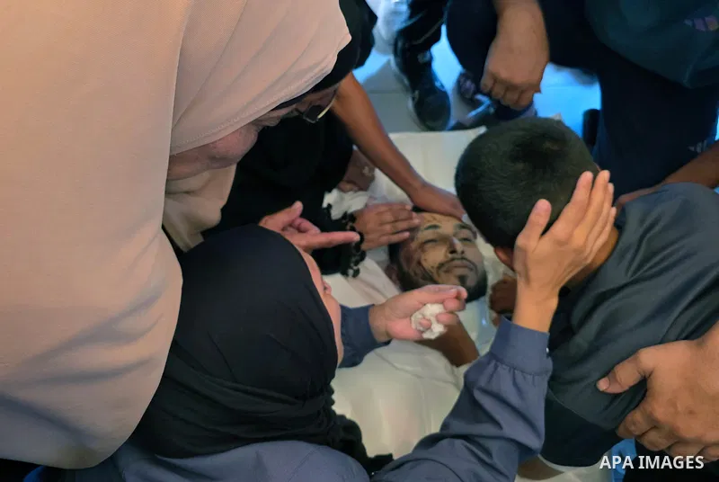 Palestinians mourn and attend the funeral of Tareq al-Ra’i at Nasser Medical Complex in Khan Younis, southern Gaza Strip, on August 17, 2026, after he died from wounds sustained in an Israeli airstrike that targeted his...
