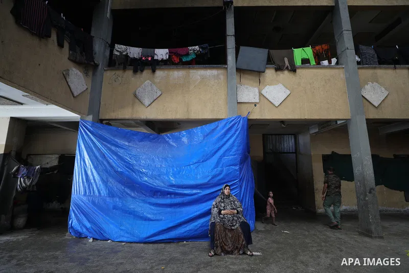 Displaced Palestinians live in tents inside a school converted into a shelter in the Nuseirat refugee camp, central Gaza Strip, on August 17, 2026, after being forced to leave their homes due to the war and being unable...